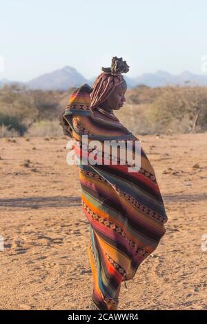KAMANJAB, NAMIBIA - SEPTEMBER 07, 2015: Unidentified woman from Himba tribe with traditional ornaments and makeup living near Kamanjab. The Himba are Stock Photo