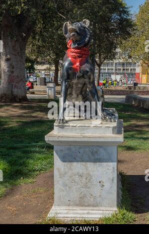 dog monument (Black Cop Killer) with red bandana in park italia, Valparaiso, Chile Stock Photo