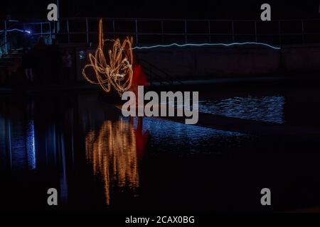 Fire spinning down at marine lake Clevedon Stock Photo