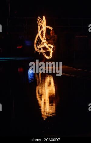 Fire spinning down at marine lake Clevedon Stock Photo