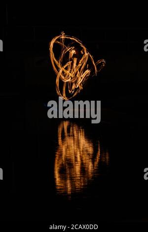 Fire spinning down at marine lake Clevedon Stock Photo