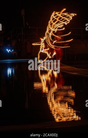 Fire spinning down at marine lake Clevedon Stock Photo