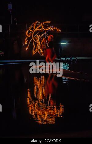 Fire spinning down at marine lake Clevedon Stock Photo