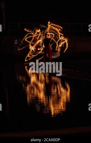 Fire spinning down at marine lake Clevedon Stock Photo