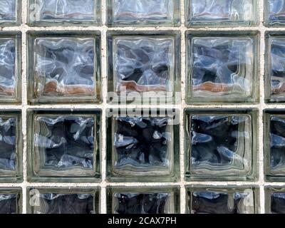 vintage close-up view wavy texture glass brick window wall, faded white grout looking down suitable for website background marketing backgrounds Stock Photo