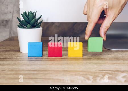 Hand arranging wood block stacking as step stair Stock Photo - Alamy