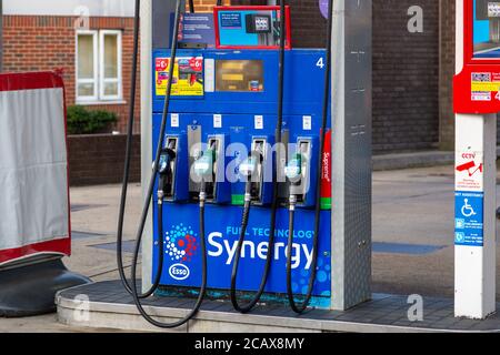 A fuel pump showing fuel nozzles on a forecourt of a petrol station Stock Photo
