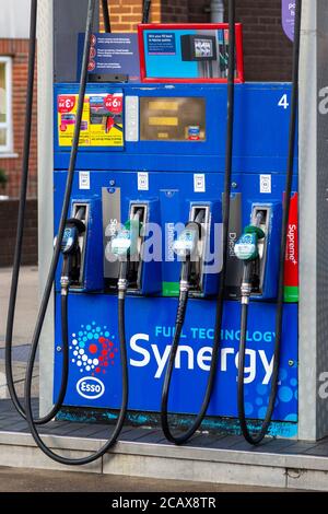 A fuel pump showing fuel nozzles on a forecourt of a petrol station Stock Photo