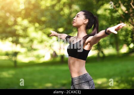 Vitality Concept. Sporty Asian Girl Exercising Outdoors, Enjoying Training In Park
