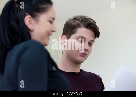 Exams Preparation. Group Of Multi-Ethnic Students Studying Together inside classroom while helping each other. Stock Photo