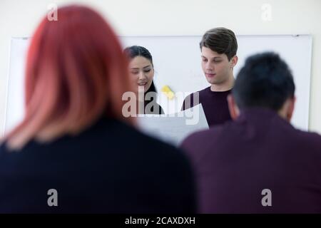 Exams Preparation. Group Of Multi-Ethnic Students Studying Together inside classroom while helping each other. Stock Photo