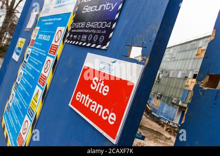 Locked entrance to a building site where an old building is being demolished to make way for housing, London, UK Stock Photo