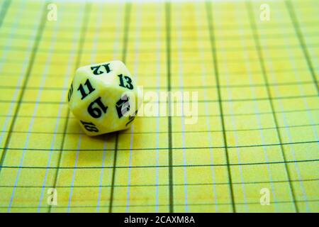 Yellow role-playing board with white dice on top Stock Photo