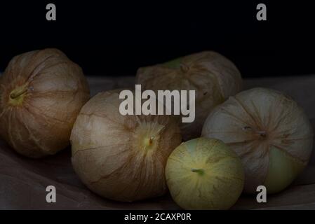 Close-up on a group of tomatillos on brown paper, cropped Stock Photo