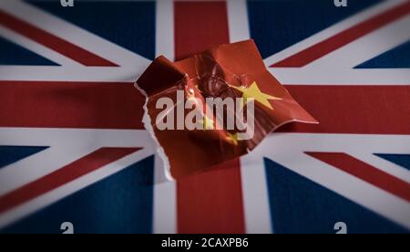 Crumpled Chinese symbol on the United Kingdom flag.. Stock Photo