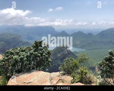 Far view from a plateau above the Blyde Canyon, South Africa on a misty and sunny day. Morning hours. Stock Photo