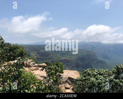 Far view from a plateau above the Blyde Canyon, South Africa on a misty and sunny day. Morning hours. Stock Photo