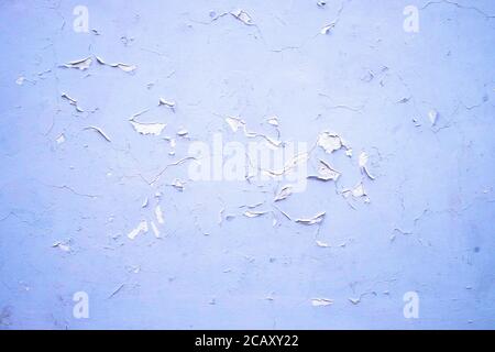 Bluish white wall with flaking paint. Stock Photo