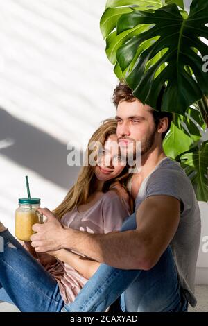 awesome man and woman are resting in the modern room with a flower. close up photo. family, friendship concept Stock Photo