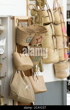 Straw bags for sale outside a shop in Eivissa, Ibiza Town, Balearic Islands, Spain Stock Photo