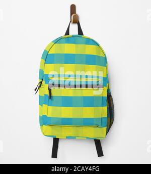 Backpack in yellow and blue squares hanging on the wall Stock Photo