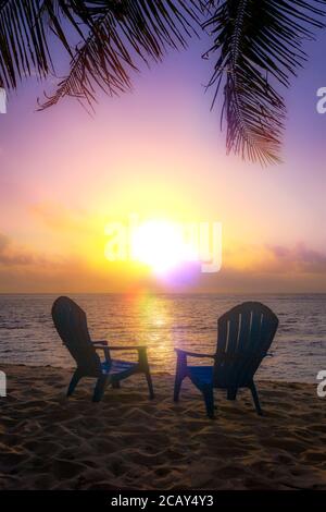Soft and dreamy sunset with two beach chairs, Grand Cayman Island Stock Photo
