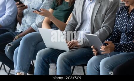 Close up cropped diverse candidates using gadgets, waiting for interview Stock Photo