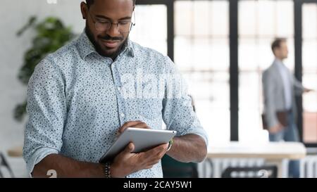 Close up focused African American businessman using computer tablet Stock Photo