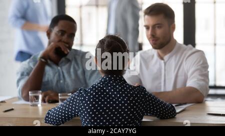 Rear view two diverse hr managers interviewing Indian woman candidate Stock Photo