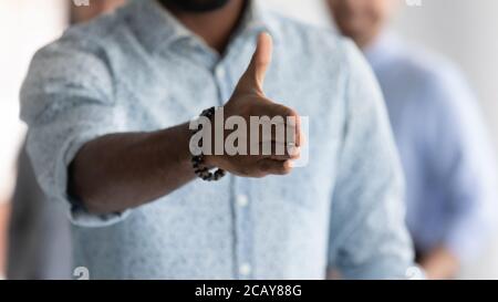 Close up African American executive extending hand for handshake Stock Photo