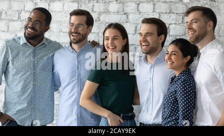 Smiling motivated successful diverse employees team standing in office Stock Photo