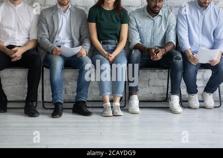 Close up cropped diverse candidates waiting for job interview Stock Photo