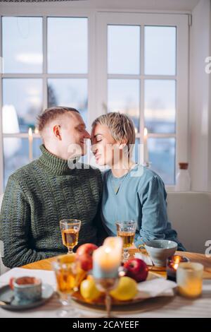 romantic atmosphere at home. young awesome couple in love. close up photo. lovers having dinner indoors . New year. Christmas Stock Photo