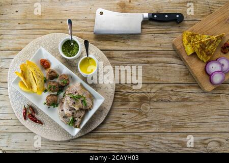 Italian main courses: Top view, copy space with cleaver on wooden table background. Stock Photo
