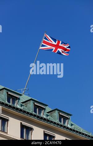 Low angle view of the British flag hoisted on a roof top. Stock Photo