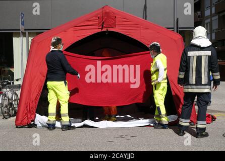 Triage tent camp for epidemy Corona Virus in the city, mobile medical unit inside a public road. Rescuers virus decontamination operation for Covid-19. Stock Photo