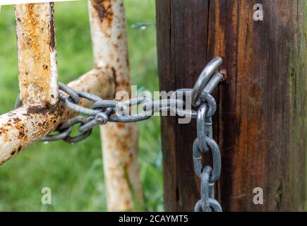 A hook and chain gate closure fitting. Stock Photo