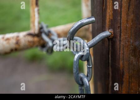 A hook and chain gate closure fitting. Stock Photo