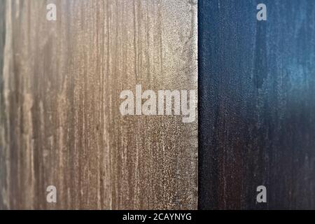 Corten steel plate, weathered metal, selective focus with offset dark and light sections, abstract graphic element. Stock Photo