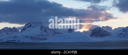 Snow capped mountains after sunset near Fredvang on the Lofoten Islands of Norway. Stock Photo