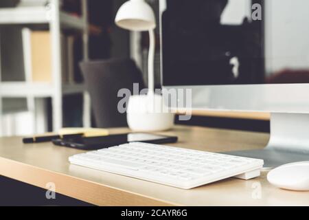 Close up keyboard desktop PC computer on table in small modern office Stock Photo