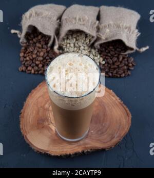 Cold brew or Nitro Coffee drink in the glass with bubble foam. Cold coffee. Stock Photo