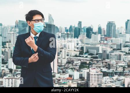Young office worker with face mask quarantine from coronavirus or COVID-19. Stock Photo