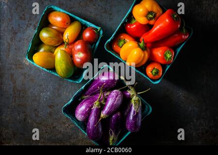 Boxes of tomatoes, peppers and fairy tale eggplants Stock Photo