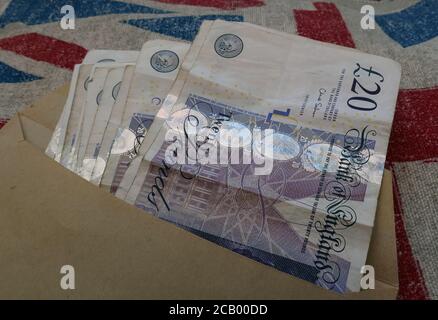 UK Sterling notes in a brown envelope, Five Pound,Ten Pound,Twenty pound,note, black economy , payment Stock Photo