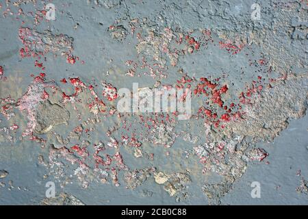 Abstract blue background texture with flecks of red and white paint and grey concrete. Stock Photo