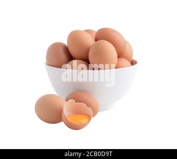Chicken eggs in the white bowl and one egg is broken with the yolk on the floor.. Raw food isolated on the white background with clipping paths Stock Photo