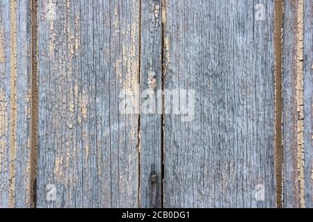 Weathered wood background with yellow and grey peeling paint texture and abstract line patterns. Stock Photo
