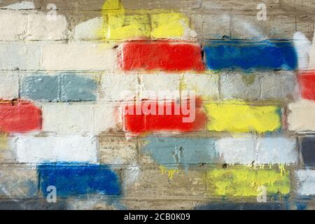 Coloured bricks on a wall background with vintage bricks, mortar and abstract colour patterns. Stock Photo