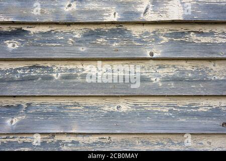Weathered wood background texture with abstract yellow paint surface and horizontal patterns. Stock Photo